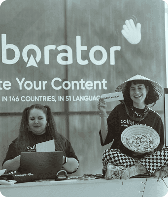 Black-and-white photo of Collaborator’s booth at the SEO Mastery Summit, with team members interacting with visitors, and company branding and information about content distribution services visible in the background